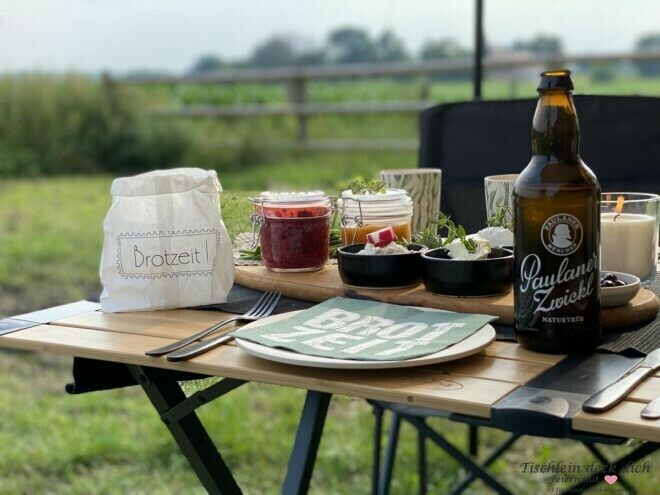 Brotzeit im Camper, dekorativ gedeckter Campingtisch 