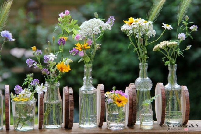 Wiesenblumen Arrangement auf Holzbrett mit Baumscheiben