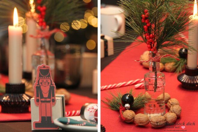 weihnachtliche Tischdekoration mit Nussknackern und Walnüssen in den Farben rot, schwarz und grün