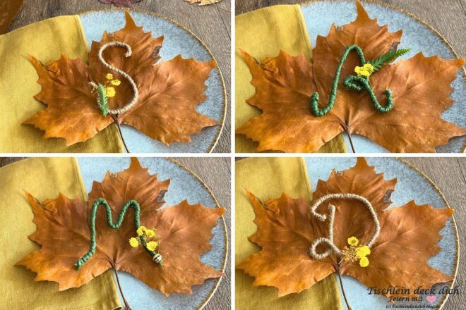 Herbstblätter mit Drahtbuchstaben und getrockneten Blüten